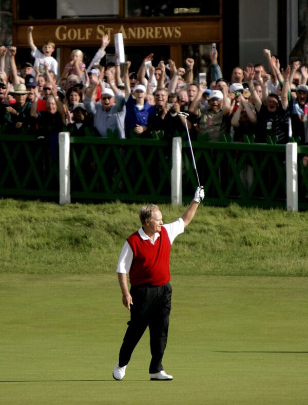 A man holding a golf club in the air.